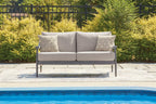 Gray loveseat with seat cushions and four geometric throw pillows