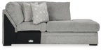 Cement gray corner chaise sofa with patterned back cushion and black end panel