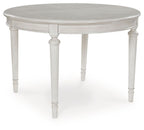 Antique white oval dining extension table with pedestal base and routed trim