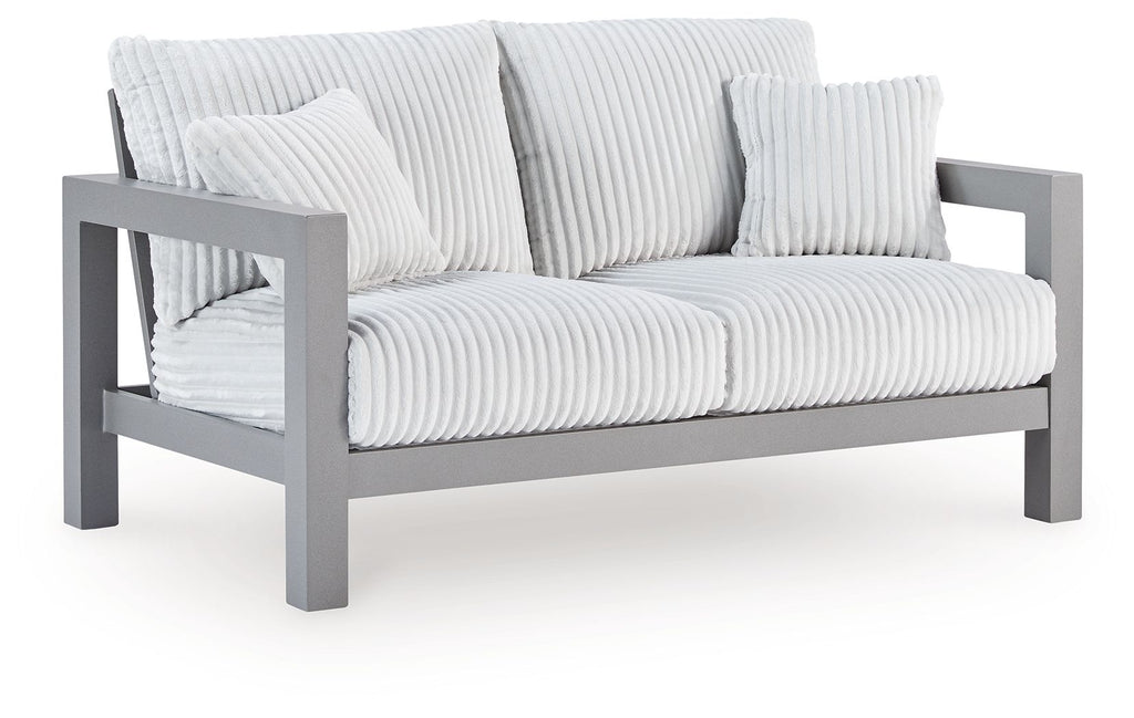 Gray outdoor loveseat with ribbed white cushions and curved armrests