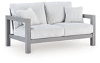 Gray outdoor loveseat with ribbed white cushions and curved armrests