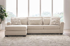 Light beige sectional sofa with chaise, square arms, and three throw pillows