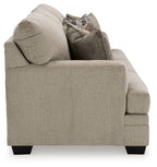 Stonemeade sofa in light taupe fabric, showing arm and back with accent pillows