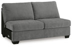 Gray upholstered armless loveseat with two seat cushions and back pillows
