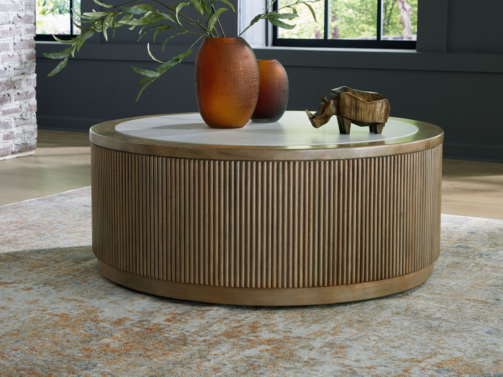 Round cocktail table with light brown fluted base and white marble-look top