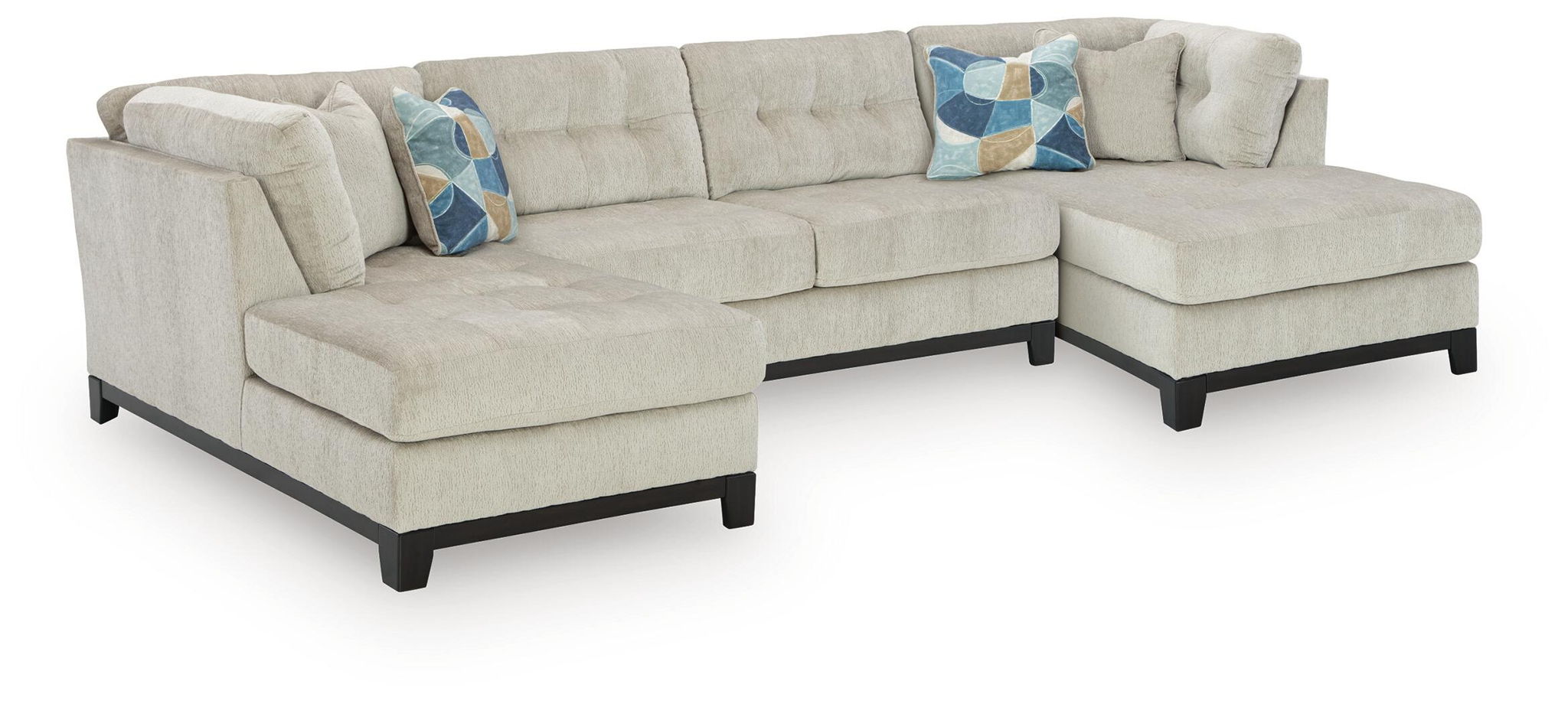 Sectional sofa with chaise in light stone upholstery and geometric throw pillows