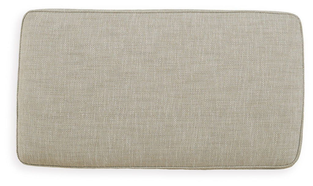 Fog beige upholstered ottoman with smooth seat and rounded edges