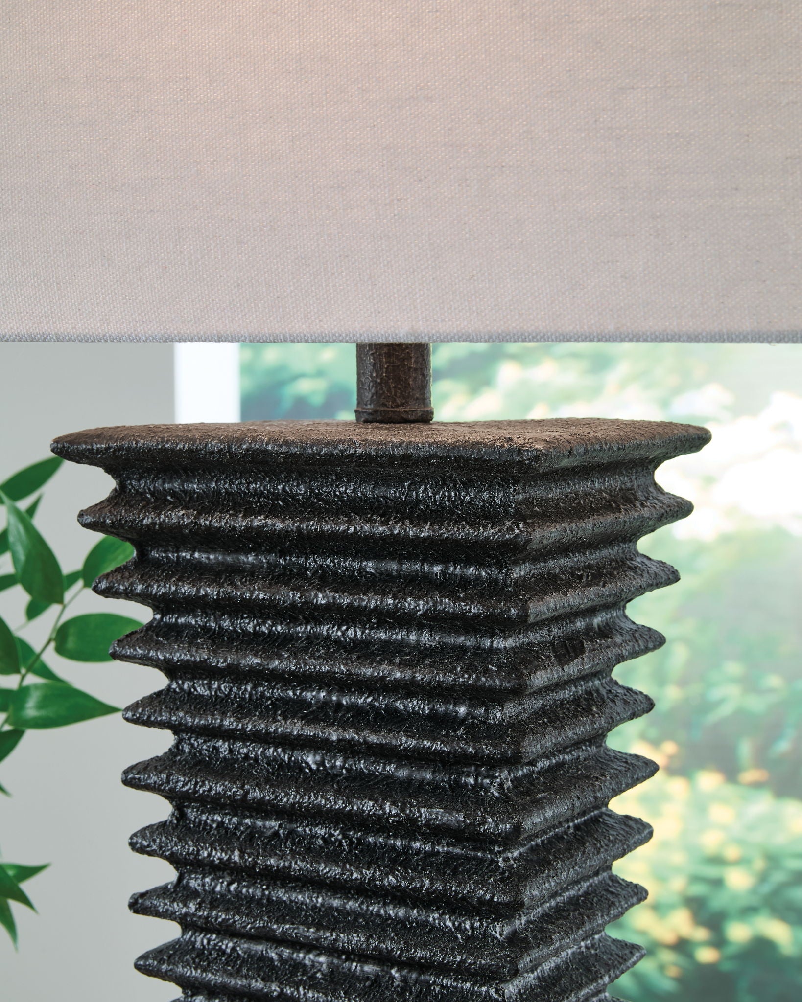 Black ribbed table lamp base with white fabric shade