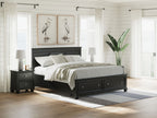 Black panel bed with paneled headboard and two footboard drawers; neatly made bed