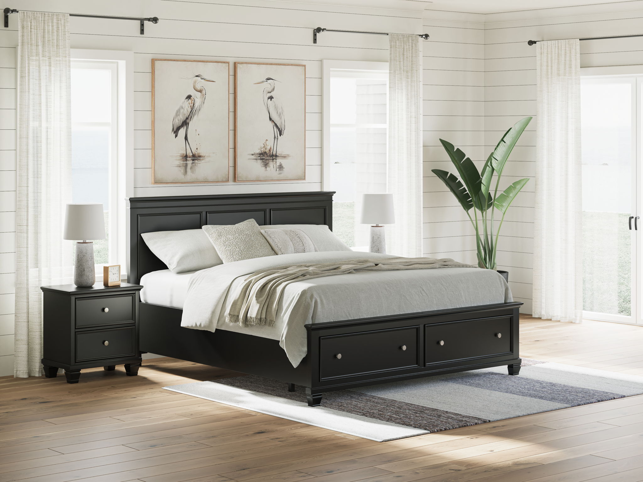 Black panel bed with paneled headboard and two footboard drawers; neatly made bed