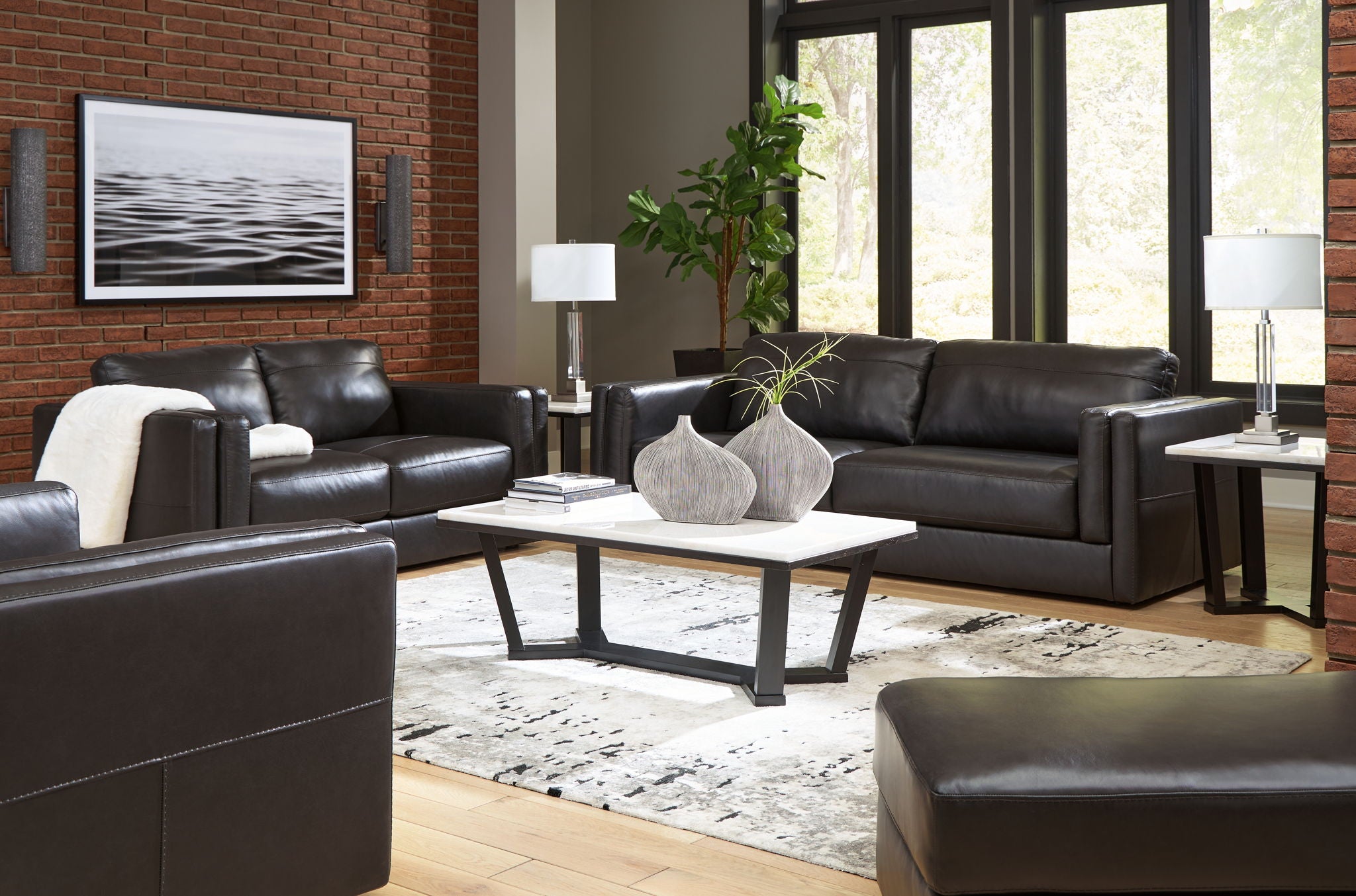 Black leather living room seating set with sofa, loveseat, and chair