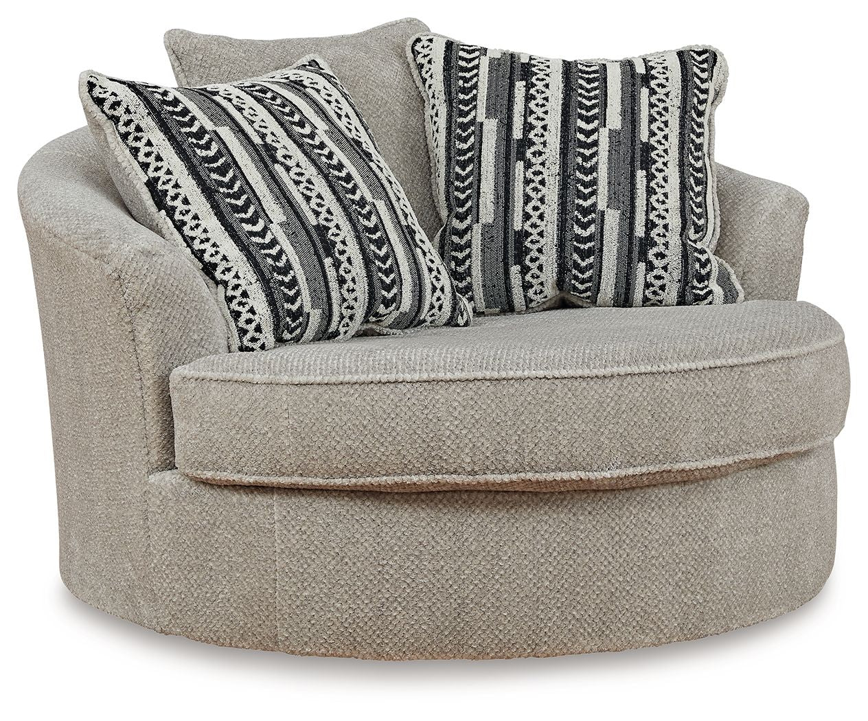 Light beige oversized swivel accent chair with round ottoman seat and patterned throw pillows