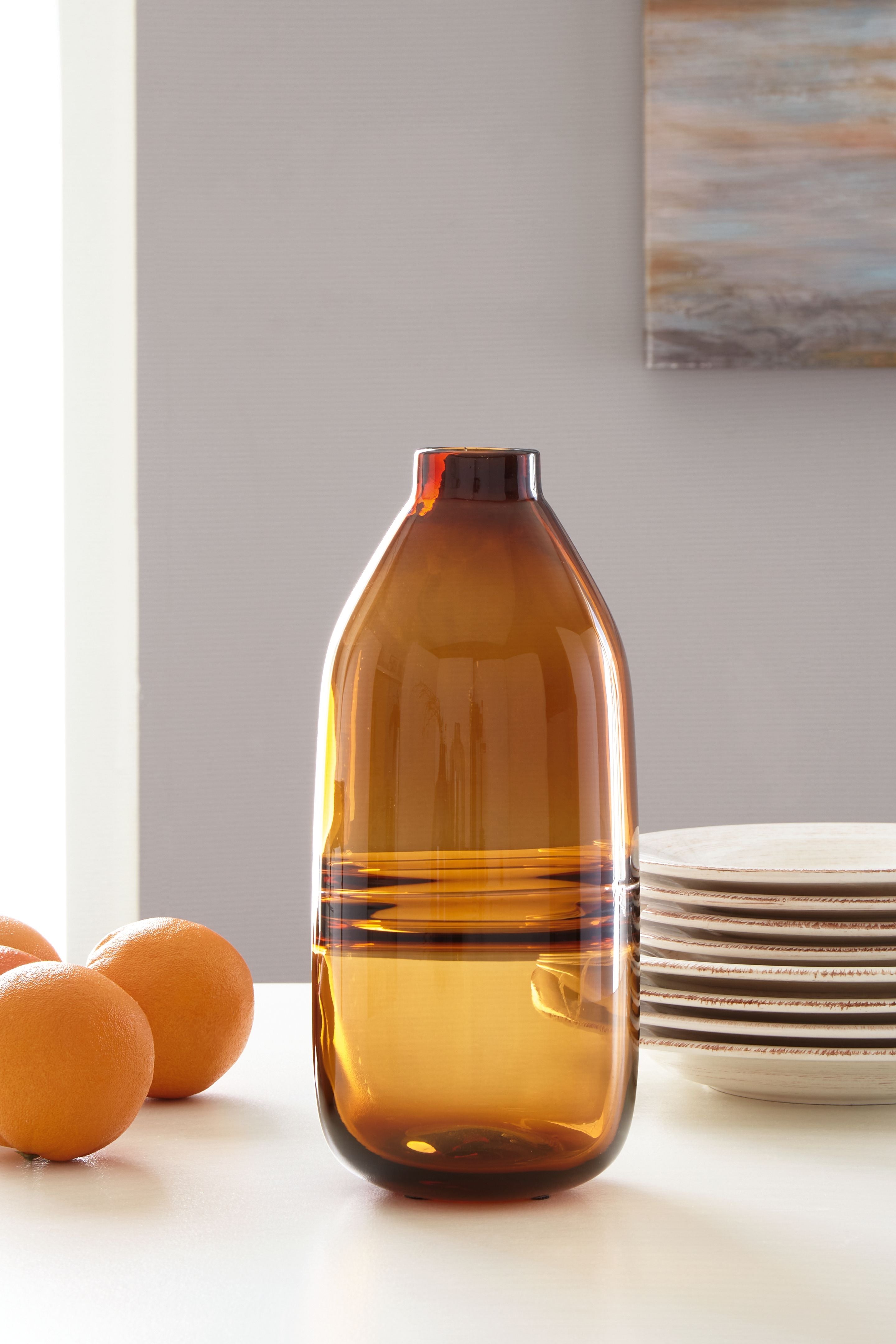 Amber glass vase with rounded shoulders and dark stripe detail near bottom