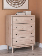 Four-drawer chest on tapered legs, light tan wood with black round knobs