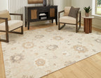 Beige rug with ornate pattern and fringed border laid on wood flooring