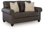 Umber loveseat with nailhead trim, two seat cushions, and two patterned throw pillows