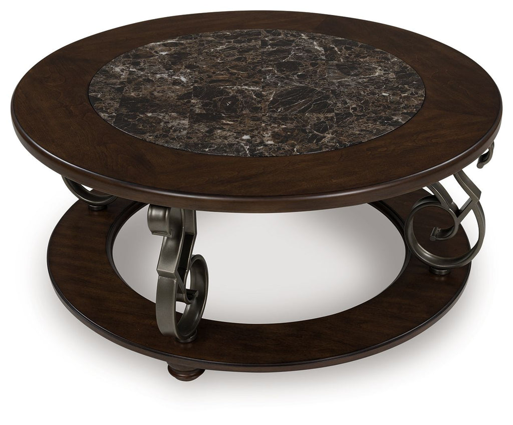Dark brown round cocktail table with marble top and lower shelf, metal scroll supports