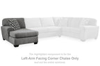 Gray left-arm facing corner chaise component with patterned throw pillow and black legs