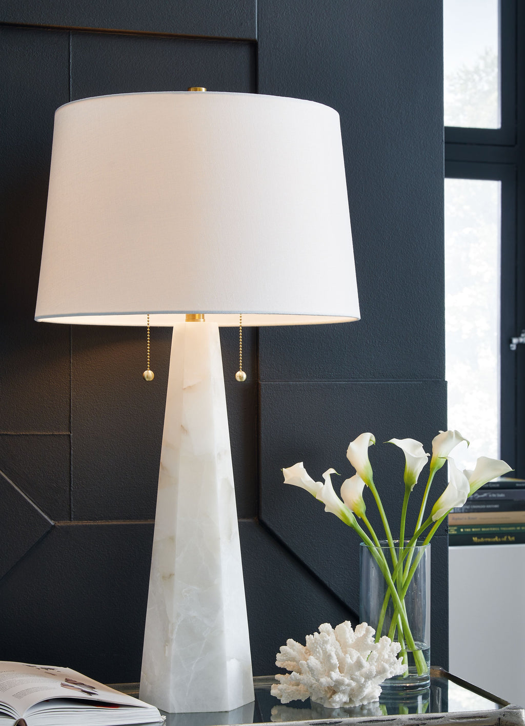 White fabric drum-shade table lamp with alabaster-style stone base