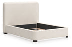 Beige upholstered bed with open storage base, padded sides, and block legs