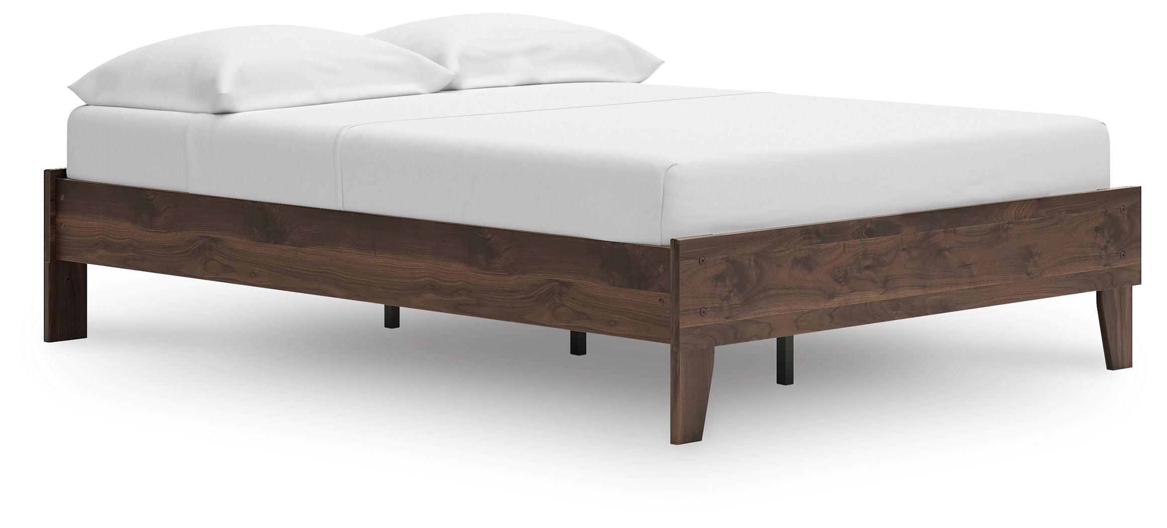 Platform bed with light brown wooden base and white bedding, low footboard