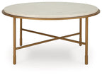 Round table with cream stone-look top and gold metal base with diagonal cross brace.