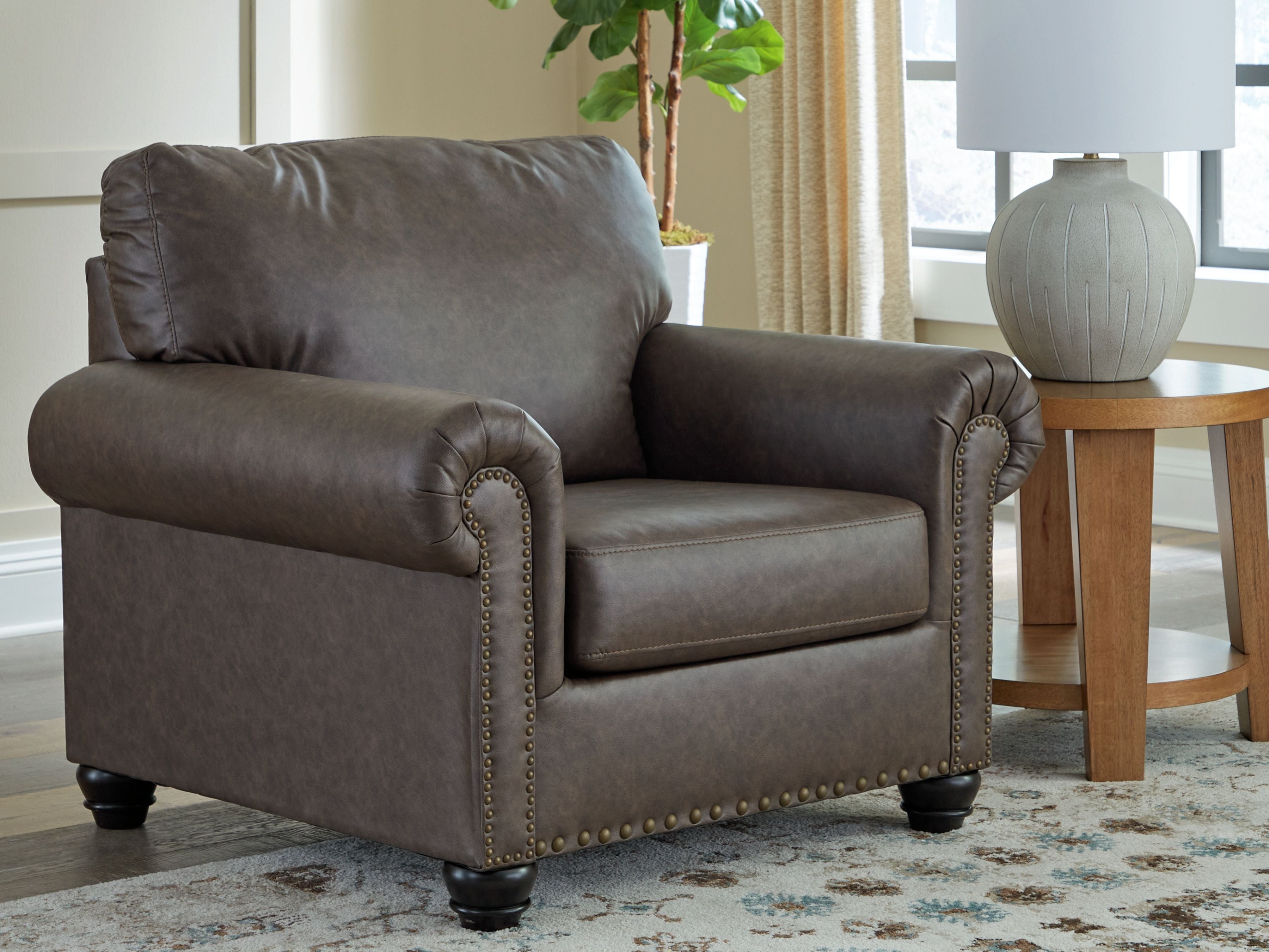 Roxmere chair three-quarter view in umber fabric with rolled arms and nailhead trim