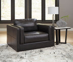 Black leather armchair with square arms and tufted cushion panels
