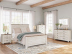 Beige panel bed with slatted headboard and footboard, neatly made with pillows