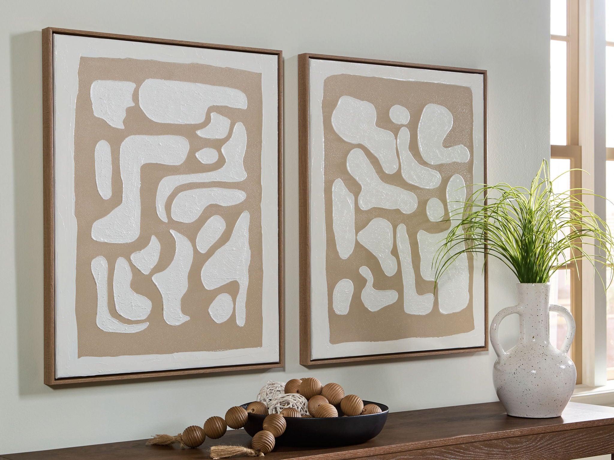 Two square framed wall art prints with beige and white abstract patterns