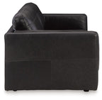 Black leather armchair with contoured back and stitched paneling