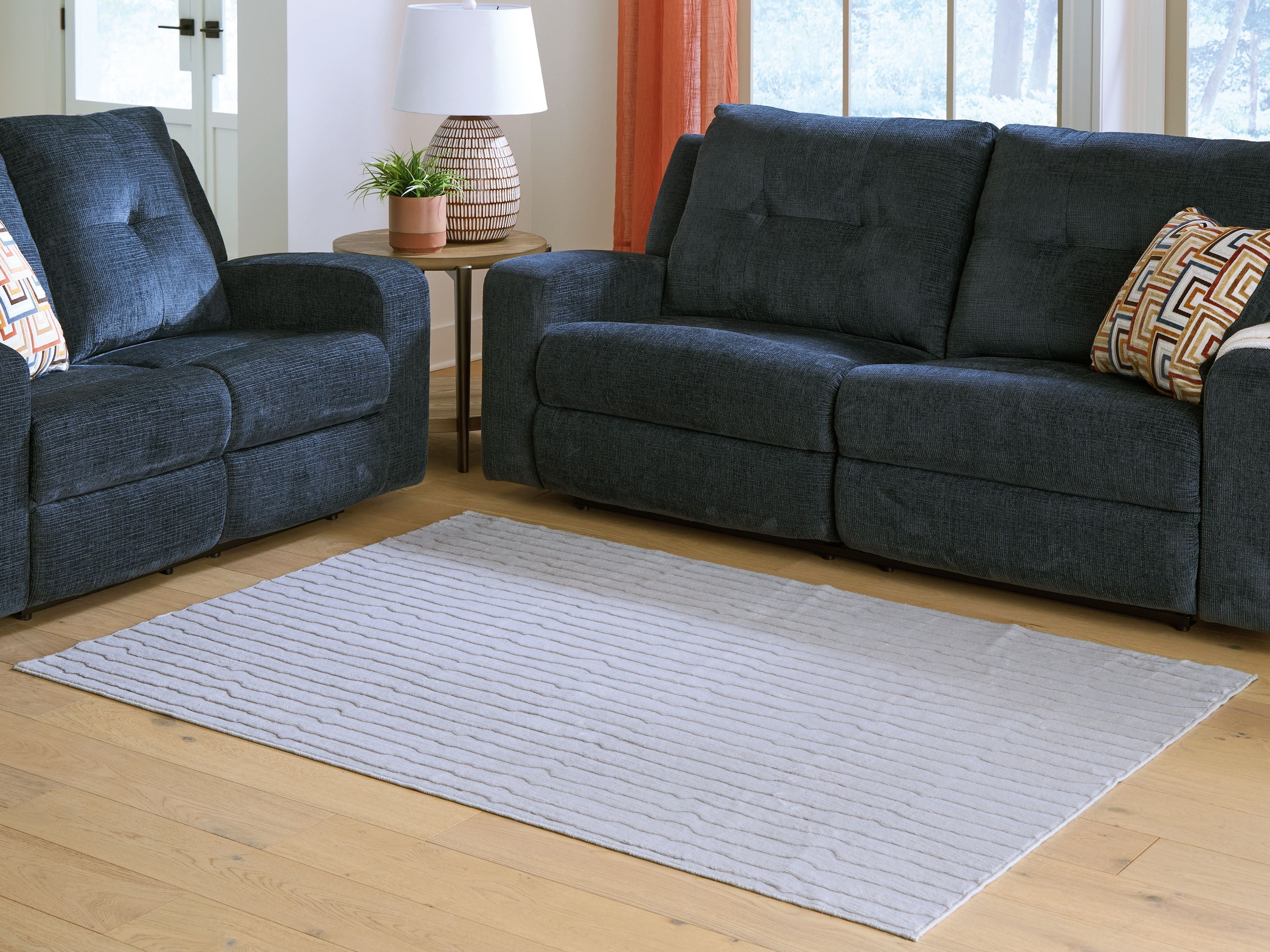 Gray washable rug with textured stripe pattern, centered on hardwood floor