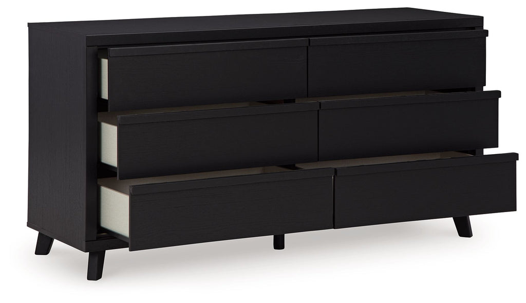 Black panel dresser showing open drawer fronts and interior rails
