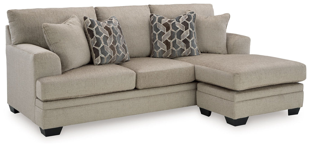 Taupe sectional sofa chaise with two geometric patterned pillows on chaise end