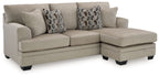 Taupe sectional sofa chaise with two geometric patterned pillows on chaise end