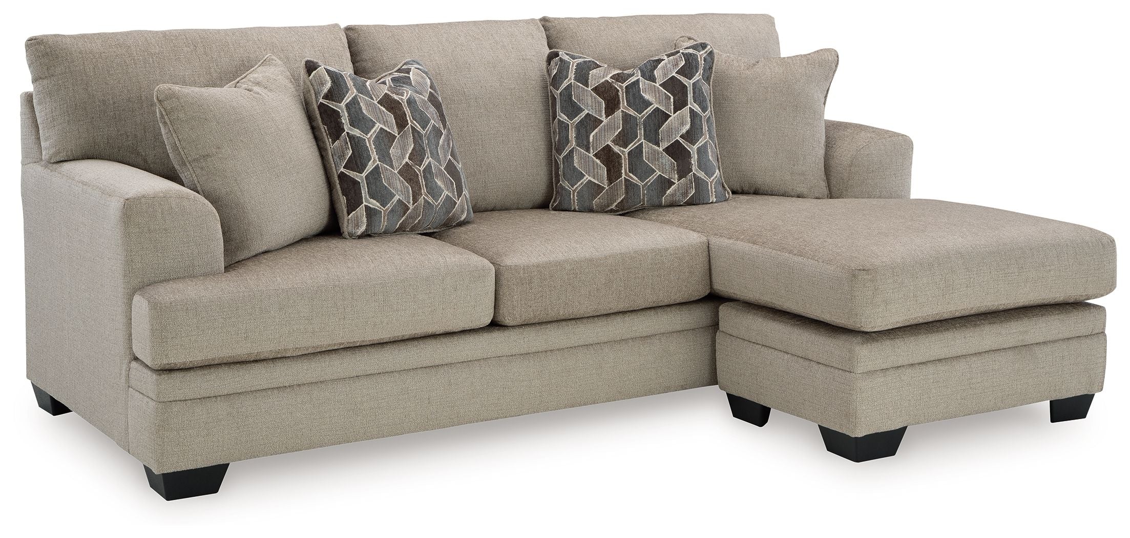 Taupe sectional sofa chaise with two geometric patterned pillows on chaise end