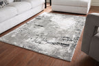 Gray area rug with distressed black speckle pattern, rectangular shape