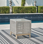 Gray wicker square end table with open weave design and tapered wood feet