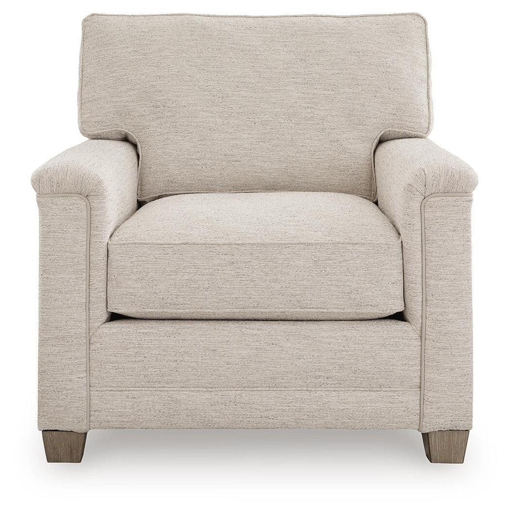Light beige upholstered armchair with tall backrest, rolled arms, and wooden legs