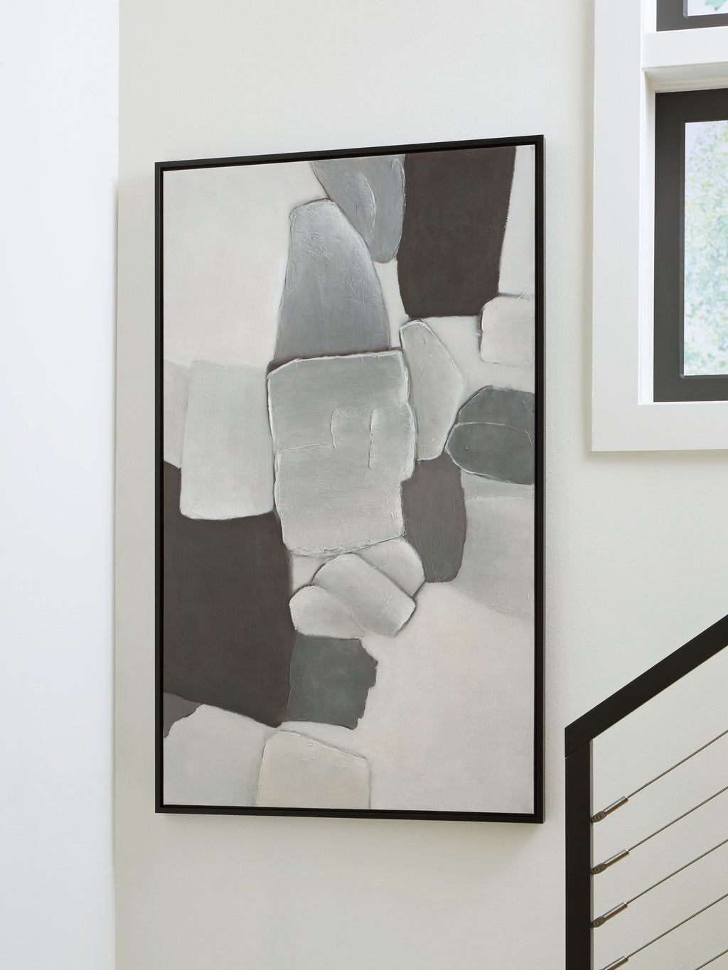 Framed abstract wall art with gray and white rectangles, black frame on a wall