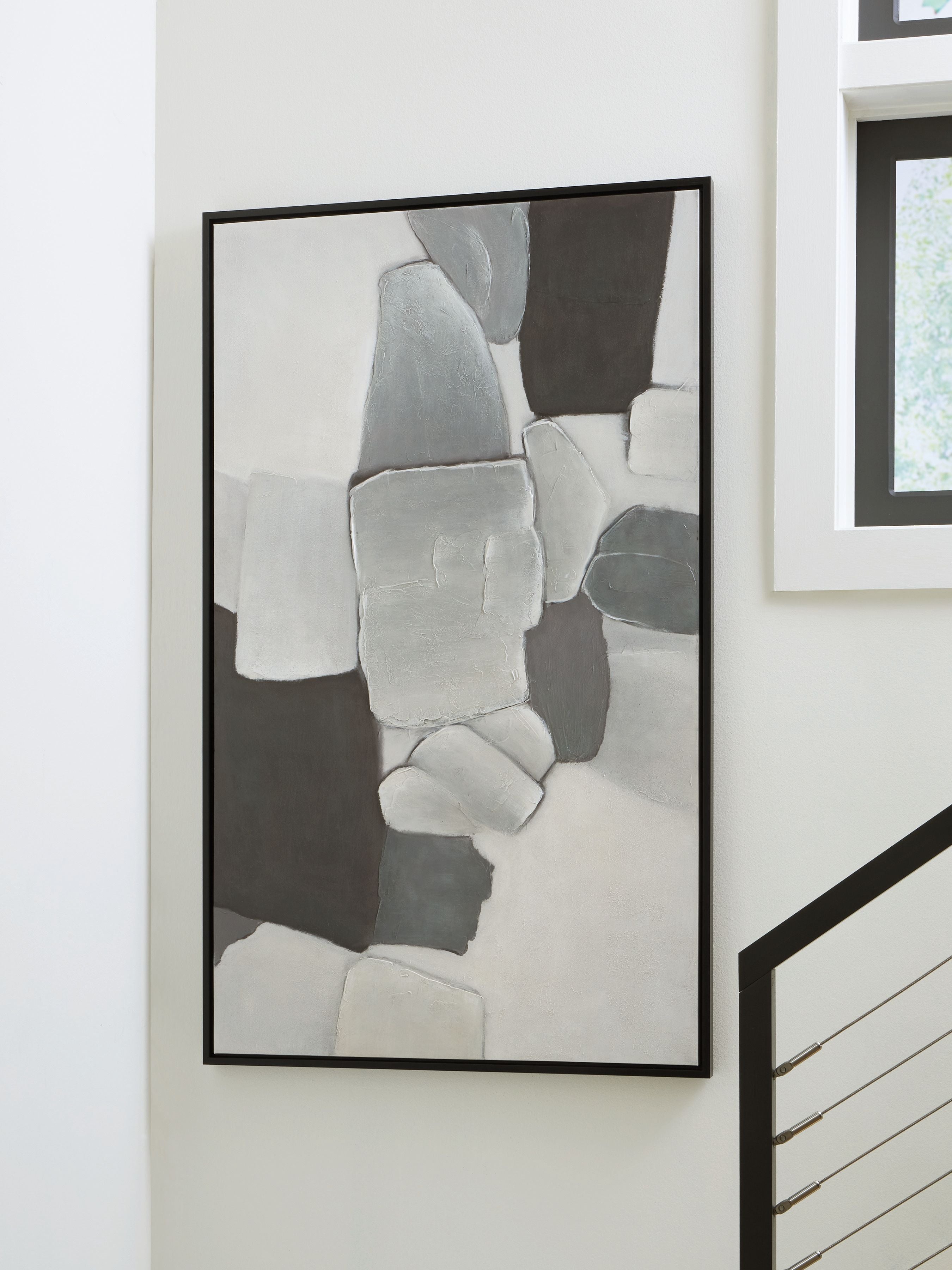 Framed abstract wall art with gray and white rectangles, black frame on a wall