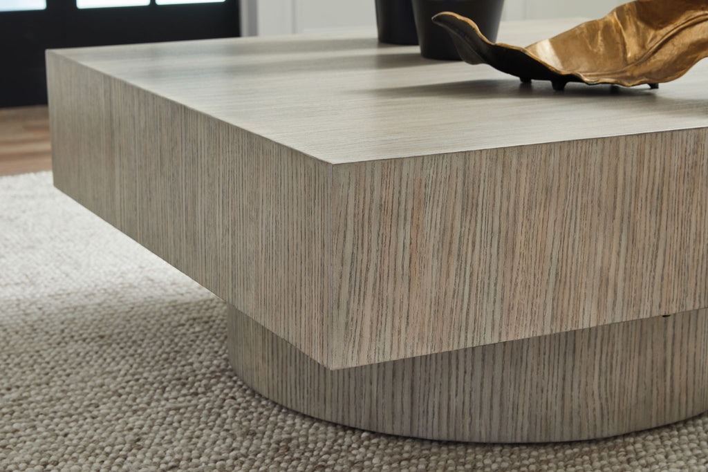 Light brown square table corner view with round pedestal base