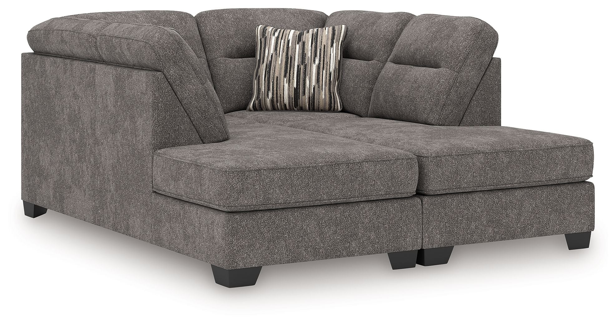 Dark gray sectional sofa chaise with tufted seat cushions and two striped accent pillows on back