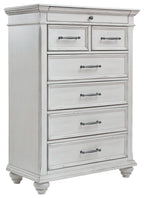 White wood chest of drawers with five drawers and metal bar pulls, turned feet.