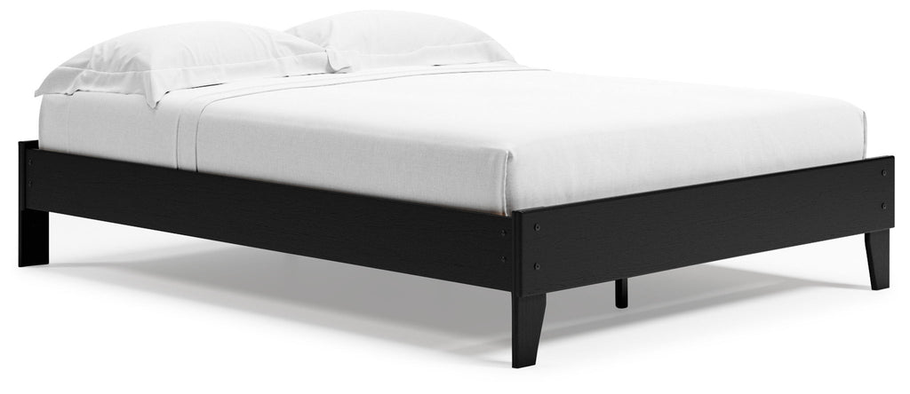 Queen platform bed in black wood frame with white mattress, tall headboard and footboard
