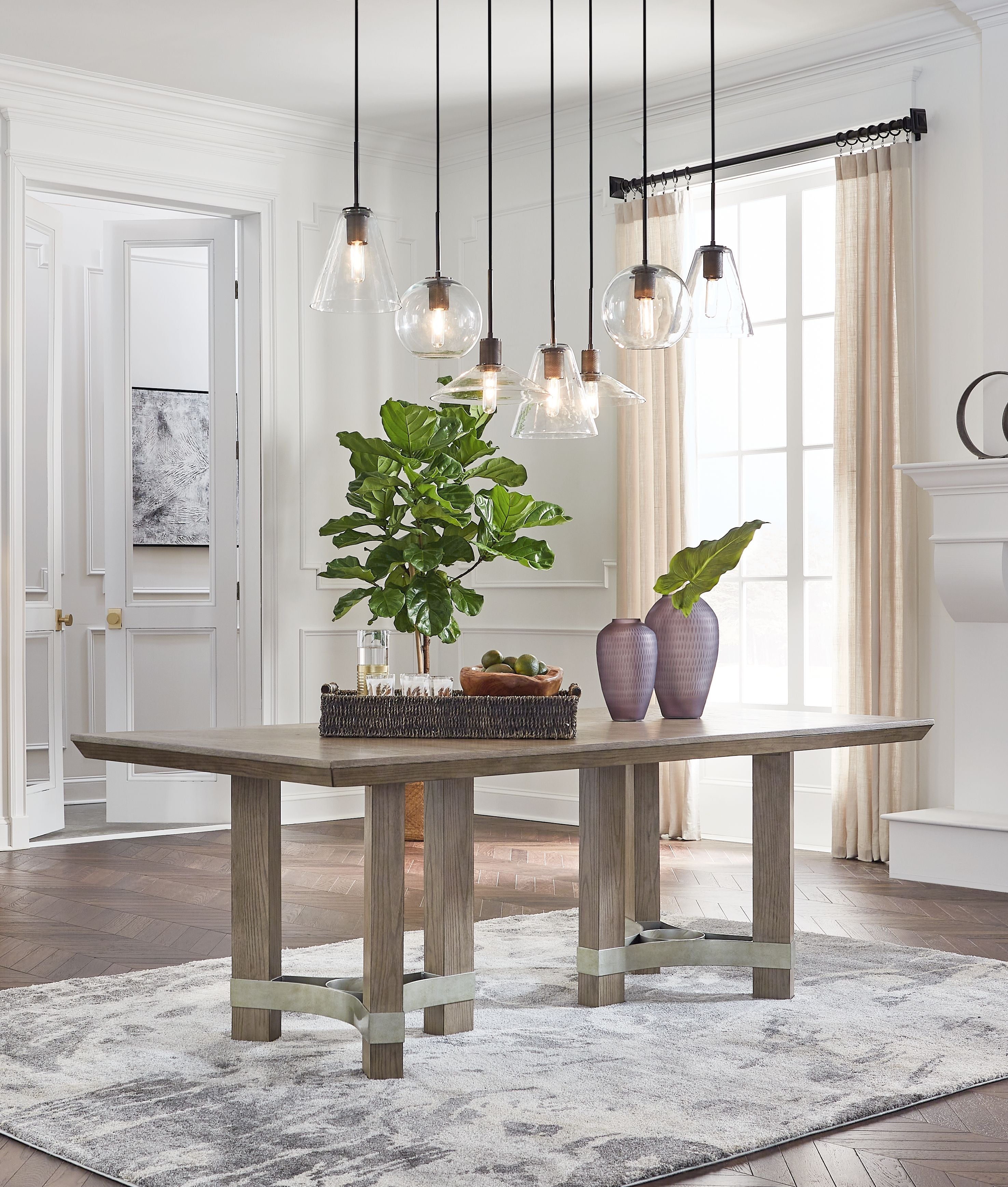 Gray rectangular dining table with central pedestal base and four legs