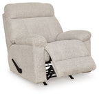 Rocker recliner chair in light gray fabric, side view with extended footrest