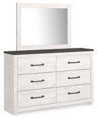 White dresser with mirror, dark top, and four drawers with bar handles