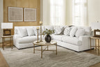 Light beige sectional sofa with chaise seating and patterned throw pillows on cushions