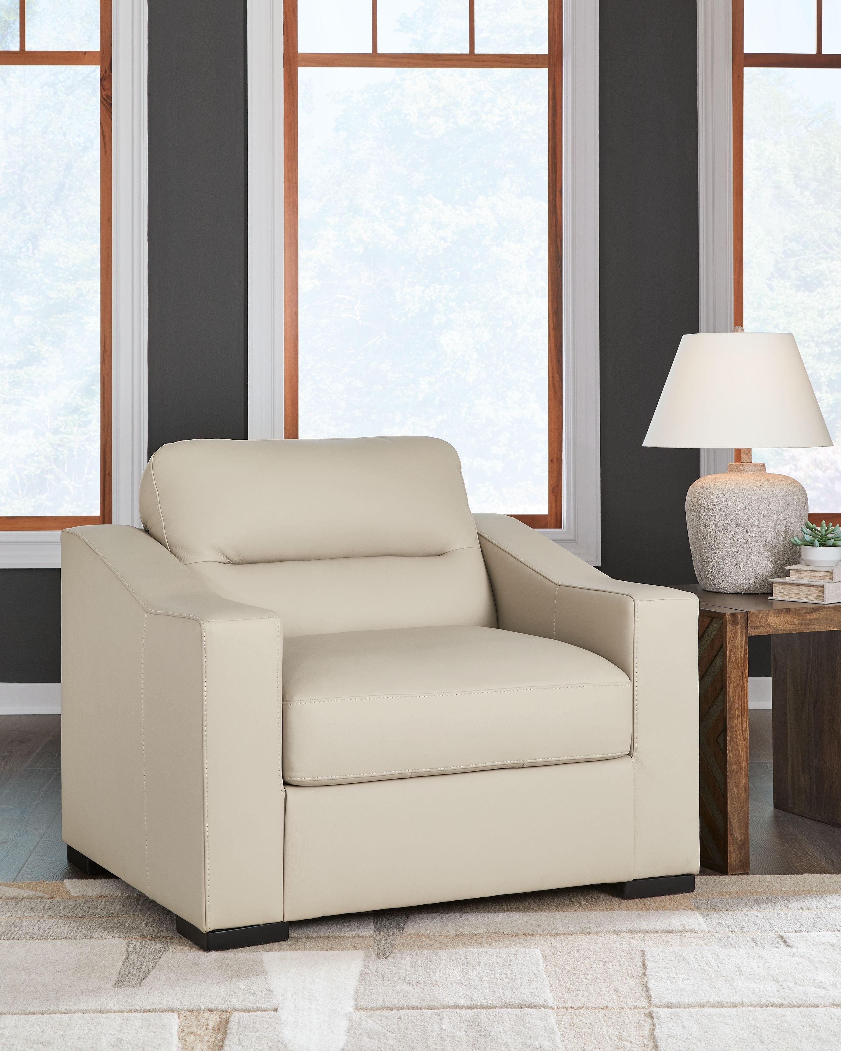 Almond single-seat armchair with tall back, padded arms, and dark base legs